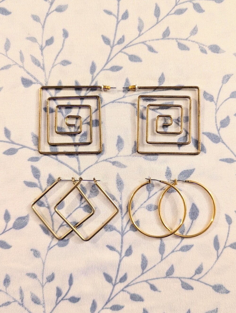 gold earrings bundle with geometric spiral, diamond, and hoop designs